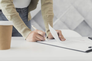 woman-signing-paper-close-up